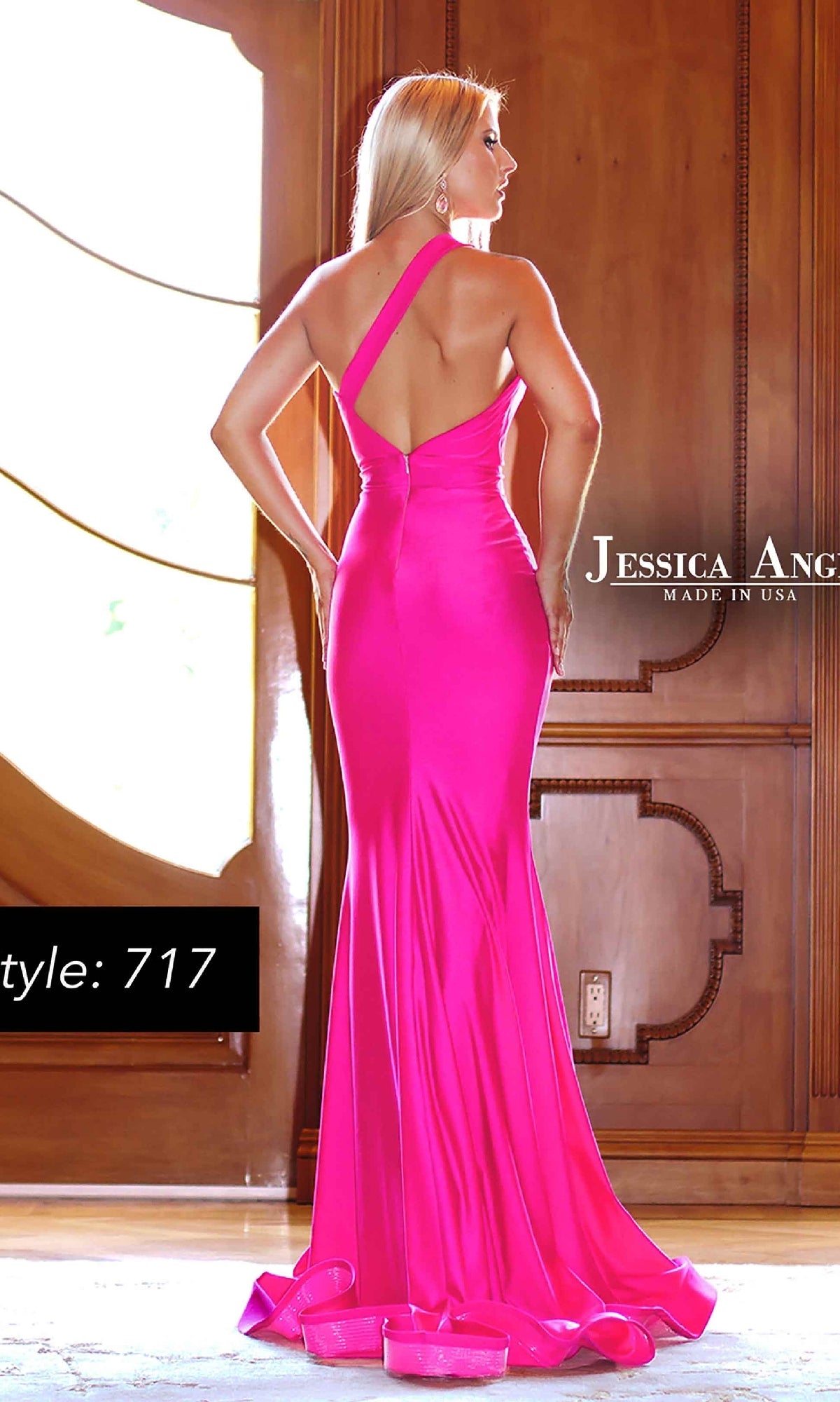 A woman in a vibrant pink One-Shoulder Cut-Out Prom Dress: Jessica Angel 717 stands with her back to the camera in an elegant room, highlighting the stunning silhouette of this designer gown.
